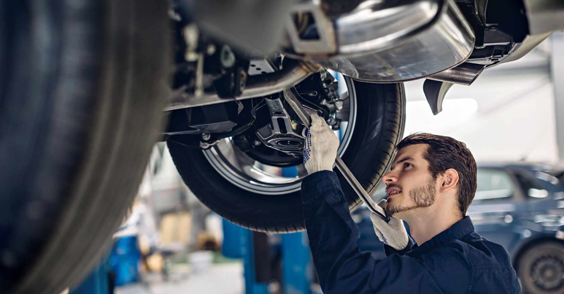 man fixing car underbody